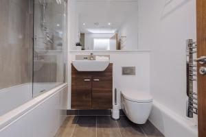 a bathroom with a sink and a toilet and a shower at Host & Stay - Waterfront Penthouse in Liverpool