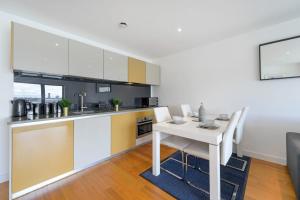 a kitchen and dining room with a table and chairs at Host & Stay - Waterfront View in Liverpool