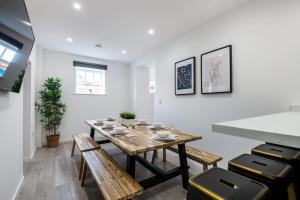 a dining room with a wooden table and benches at Host & Stay - The Roscoe Carriage House in Liverpool
