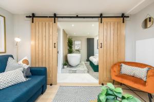 a living room with a door leading to a bathroom at Host & Stay - The Georgian Coach House 1 in Liverpool