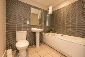 a bathroom with a toilet and a sink and a tub at Host & Stay - Ropewalks Apartment in Liverpool