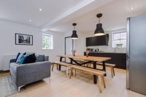 a kitchen and living room with a table and a couch at Host & Stay - The Roscoe Coach House in Liverpool