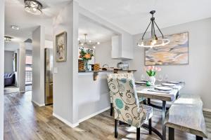 a dining room and kitchen with a table and chairs and a dining room gmaxwell gmaxwell at The Alfar by Samsara Resort Private Entry Panorama Top View 3BR 2TH in Canmore