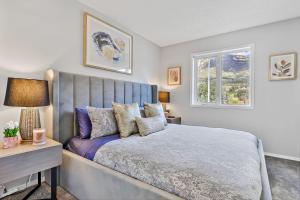 a bedroom with a large bed and a window at The Alfar by Samsara Resort Private Entry Panorama Top View 3BR 2TH in Canmore