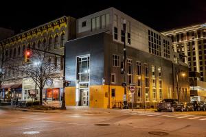 a city street at night with a traffic light and buildings at The Finnley Hotel in Grand Rapids