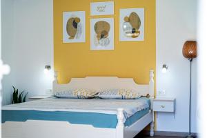 a bedroom with a bed with a yellow wall at Apartments Gruda in Cetinje