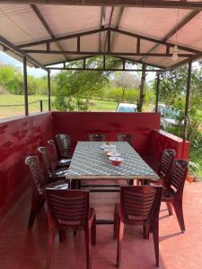 d'une terrasse avec une table et des chaises. dans l'établissement Wild Valley Club, à Masinagudi