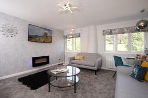 a living room with a couch and a table at Kentmere Haven - 2 Bedroom - Cycle Storage in Kendal