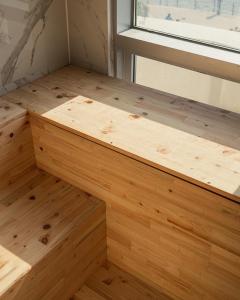 a wooden shelf in a room with a window at De Homme Hotel in Busan