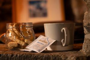 a cup of coffee and a jar of bread at Romantic rural couples retreat in the stunning village of Crosthwaite, Lyth Valley in Kendal