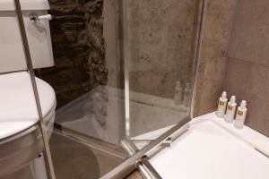 a shower with a glass door and a toilet at Romantic rural couples retreat in the stunning village of Crosthwaite, Lyth Valley in Kendal