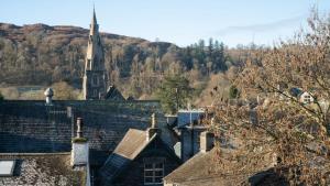 a view of roofs of houses with a church at Calm - 1BR - 1BA - Apartment - Central Ambleside in Ambleside
