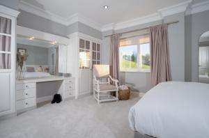 a bedroom with a bed and a sink and a mirror at Brand New - Contemporary - 2 Bedroom - 2 Bathroom - Spacious Apartment - Lake Views in Ambleside