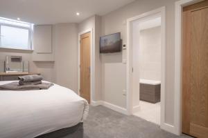 a bedroom with a bed and a tv on the wall at The Hideaway with Cosy Fireplace by LetMeStay in Ambleside