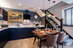 a kitchen and dining room with a table and chairs at Spacious - Contemporary Home - Central Ambleside - Parking in Ambleside