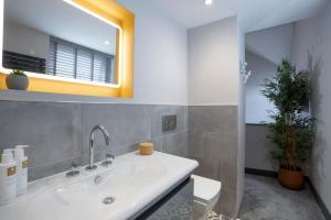 a bathroom with a sink and a mirror at Spacious - Contemporary Home - Central Ambleside - Parking in Ambleside