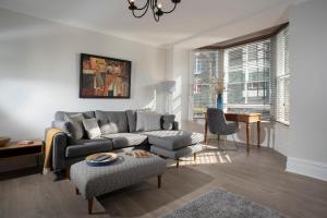 a living room with a couch and a table at Redbanks Apartment in Ambleside