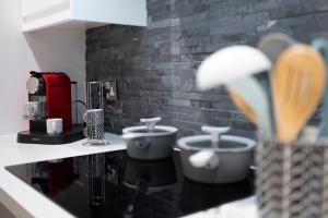 a kitchen counter with two cups on a counter top at Redbanks Apartment in Ambleside