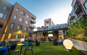 a courtyard in a city with chairs and tables at Vibrant 2BR Corner Suite and Free Parking at CityWay in Indianapolis