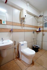 a bathroom with a toilet and a sink at Kadampanattu's Homestay in Ernakulam