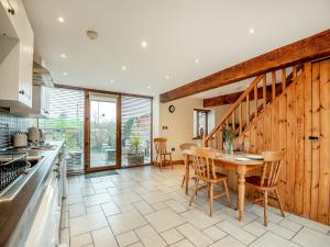 a kitchen and dining room with a table and chairs at The Granary in Bream