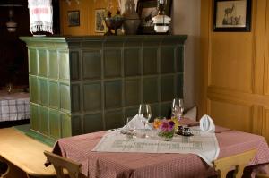 a table with a table cloth and flowers on it at Gämsle Hotel, Wirtshaus & mehr in Schoppernau