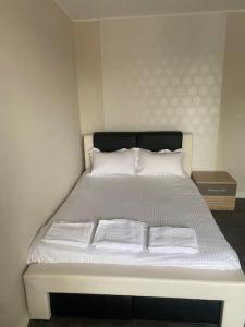 a bed with white sheets and pillows in a room at Appartement 2 in Les Minières