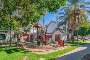 a playground in front of a house with trees at Metro PHX STUDIO QUEEN UPSTAIRS sleeps 4 modern design best amenities in Phoenix