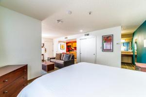 a bedroom with a bed and a living room at Metro PHX STUDIO QUEEN UPSTAIRS sleeps 4 modern design best amenities in Phoenix