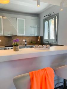 a kitchen with an orange towel on a counter at Seaview & Jacuzzi summer residence in Mýkonos City