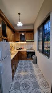 a kitchen with a tile floor and a refrigerator at Kallmet Villa in Kalmet