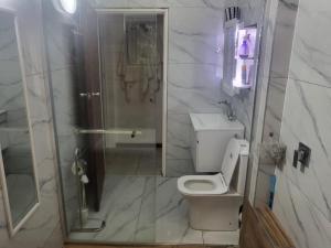 a bathroom with a toilet and a walk in shower at Eden Wilds 38 in Port Edward +29 photos