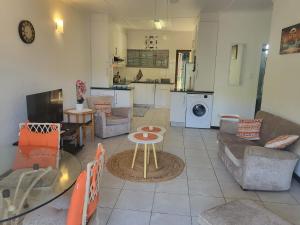 a living room with a couch and a table at Eden Wilds 38 in Port Edward