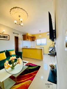a living room with a table and a couch at RESIDENCE LUXALYS in Yaoundé