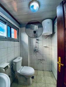 a small bathroom with a toilet and a sink at RESIDENCE LUXALYS in Yaoundé