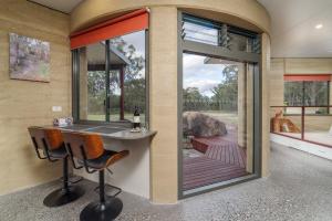 a home office with a view of a deck at Earth & Soul Retreat in Cannon Creek