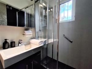 a bathroom with a shower and a sink and a shower at Vouliagmeni Iasonos Residence Central Stylish Flat in Athens +33 photos