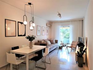 a living room with a table and a couch at Vouliagmeni Iasonos Residence Central Stylish Flat in Athens