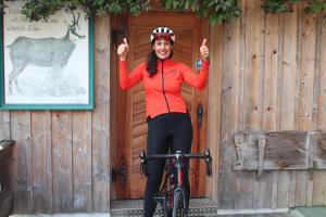 a woman on a bike giving the thumbs up at Gämsle Hotel, Wirtshaus & mehr in Schoppernau