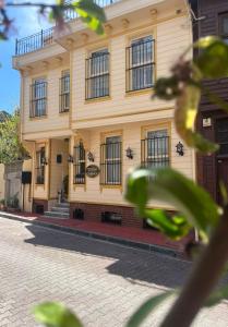 a yellow building with black windows on a street at Ottoman Elegance Hotel in Istanbul