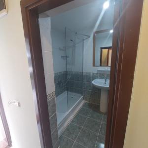 a bathroom with a shower and a sink at PİGALE BEACH RESORT in Kuşadası