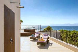Un balcón con sillas y vistas al océano. en Casa Pura - Luxuriöses Ferienhaus mit Meerblick, en Llucmajor
