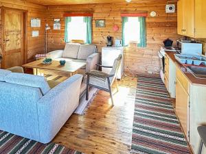 a living room with a couch and a table at 5 person holiday home in FARSUND-By Traum in Helle