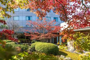 an office building with a garden in front of it at ANA Crowne Plaza Kanazawa by IHG in Kanazawa