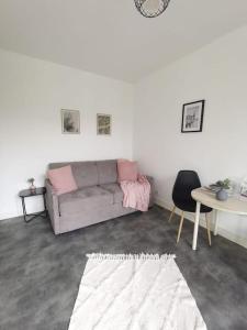 a living room with a couch and a table at Le Calme - Appartement 2 pièces in Alfortville