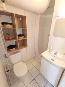 a white bathroom with a toilet and a sink at Le Calme - Appartement 2 pièces in Alfortville