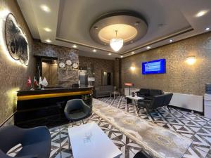 a hotel lobby with a piano and chairs at inDİANA HOTEL in Van