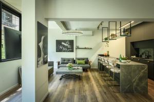 a living room and kitchen with a table and a bar at Sophisticated 1BR Apartment in Central Tel Aviv by Sea N' Rent in Tel Aviv
