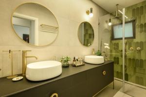 a bathroom with two sinks and two mirrors at Sophisticated 1BR Apartment in Central Tel Aviv by Sea N' Rent in Tel Aviv