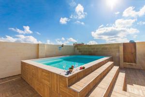 a large swimming pool with a hot tub at Naduri, Beautiful Gozitan Villa plus Pool - Happy Rentals in Nadur
